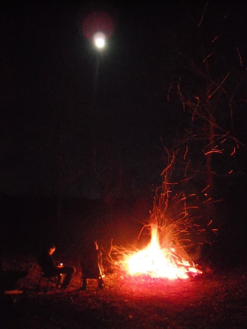 Campfire with the full moon overhead.